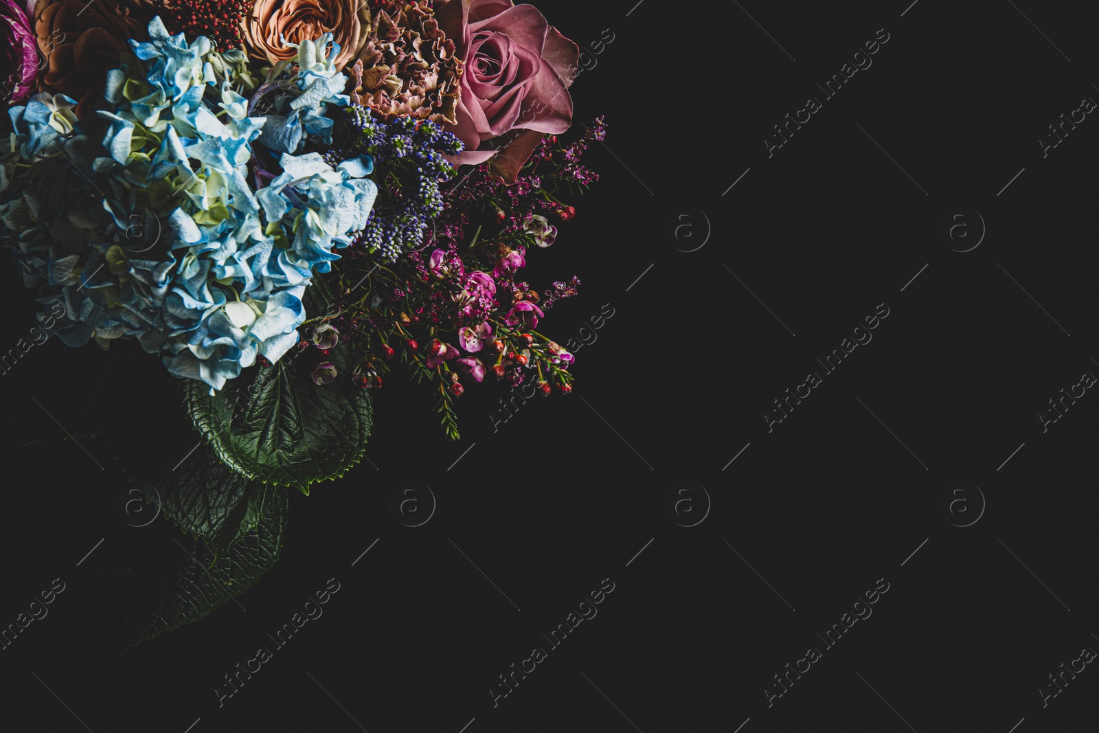 Photo of Beautiful bouquet of different flowers on black background, space for text. Floral card design with dark vintage effect