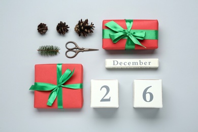 Photo of Flat lay composition with block calendar and gifts on white background. Boxing day concept