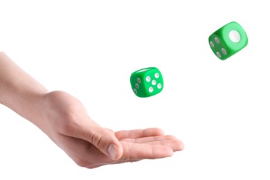 Man throwing green dice on white background, closeup