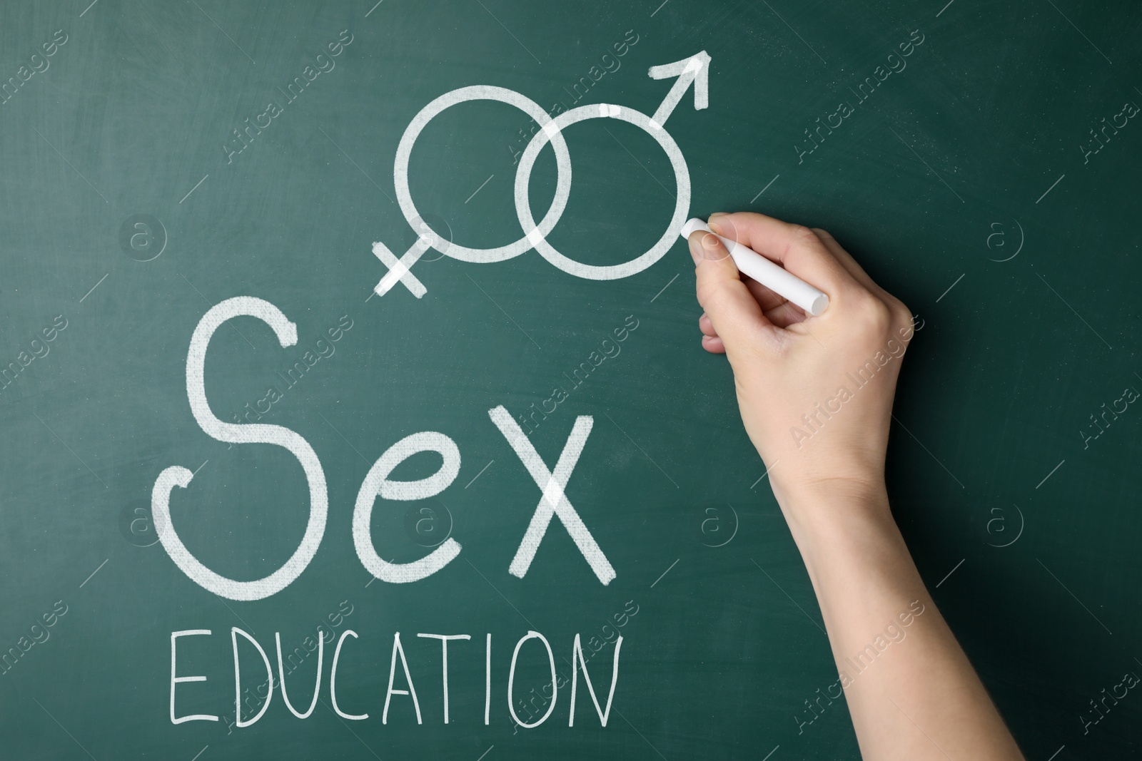 Image of Sex education. Woman drawing male gender sign on green chalkboard, closeup