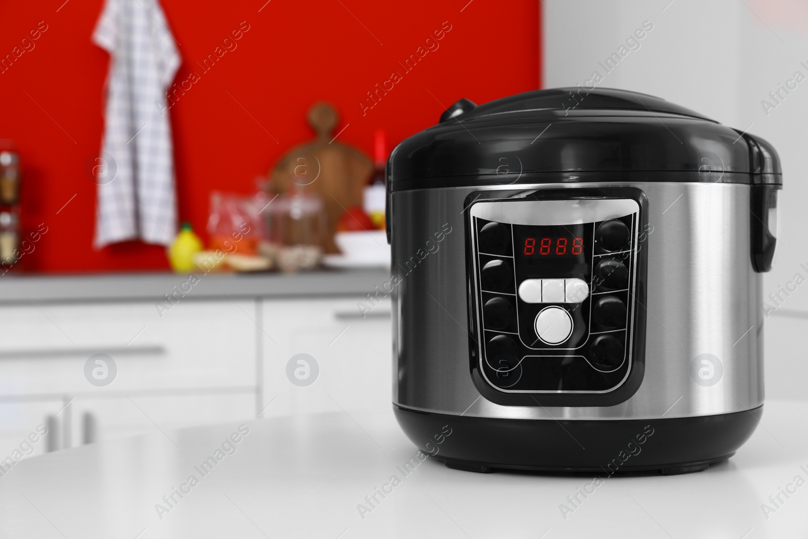 Photo of New modern multi cooker on table in kitchen. Space for text