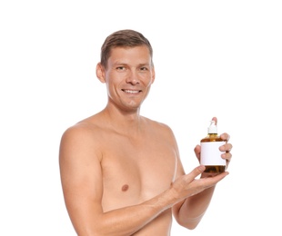 Portrait of man holding bottle with liquid soap on white background