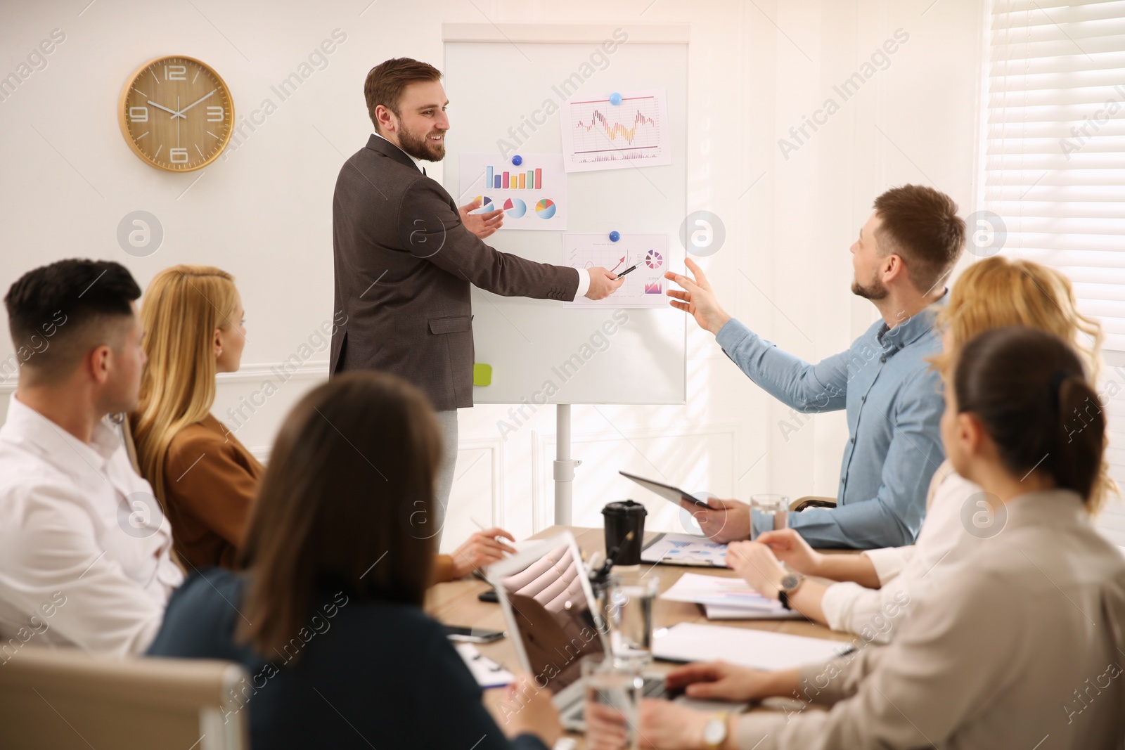 Photo of Businesspeople having meeting in office. Management consulting