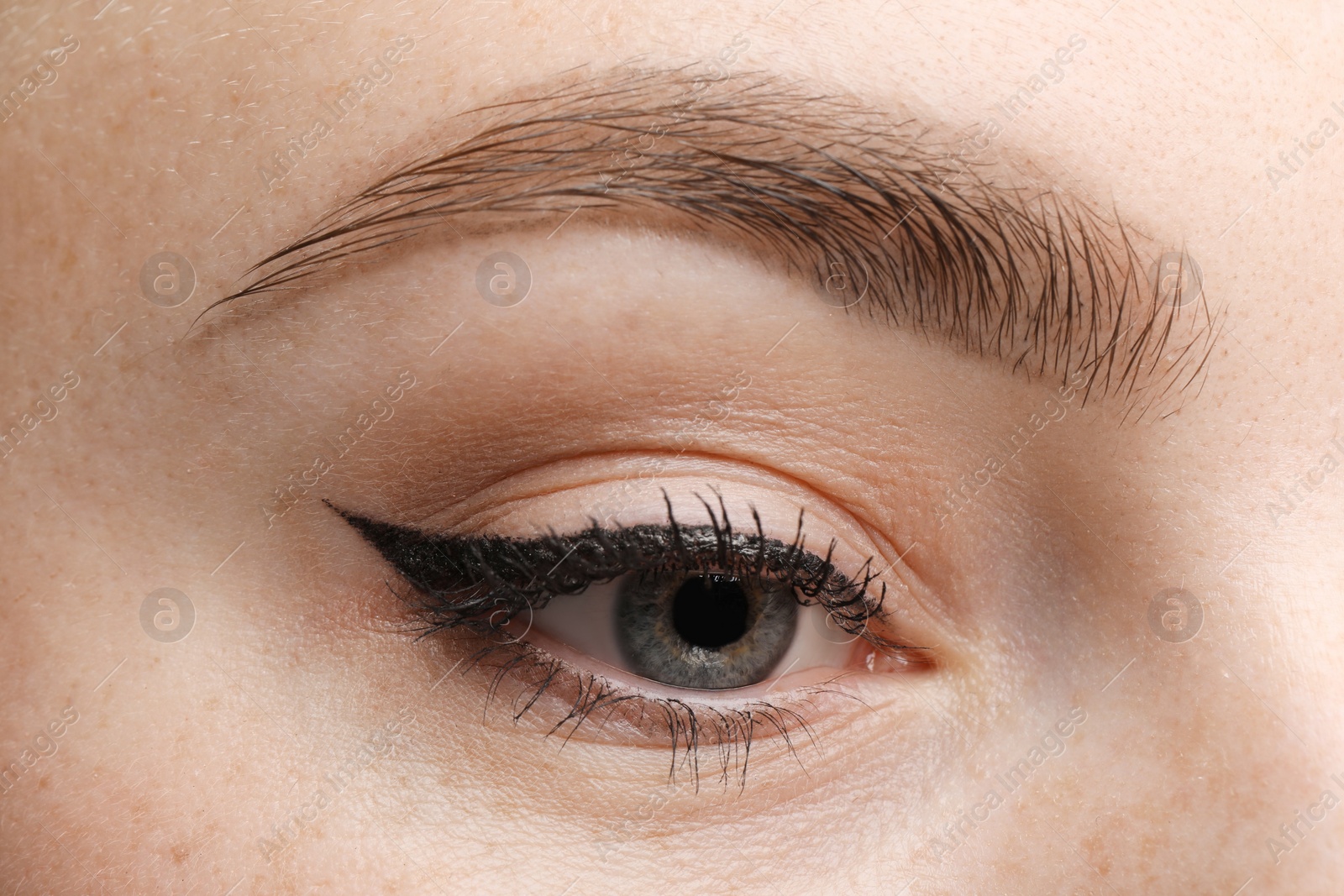 Photo of Makeup product. Woman with black eyeliner and beautiful eyebrow, closeup