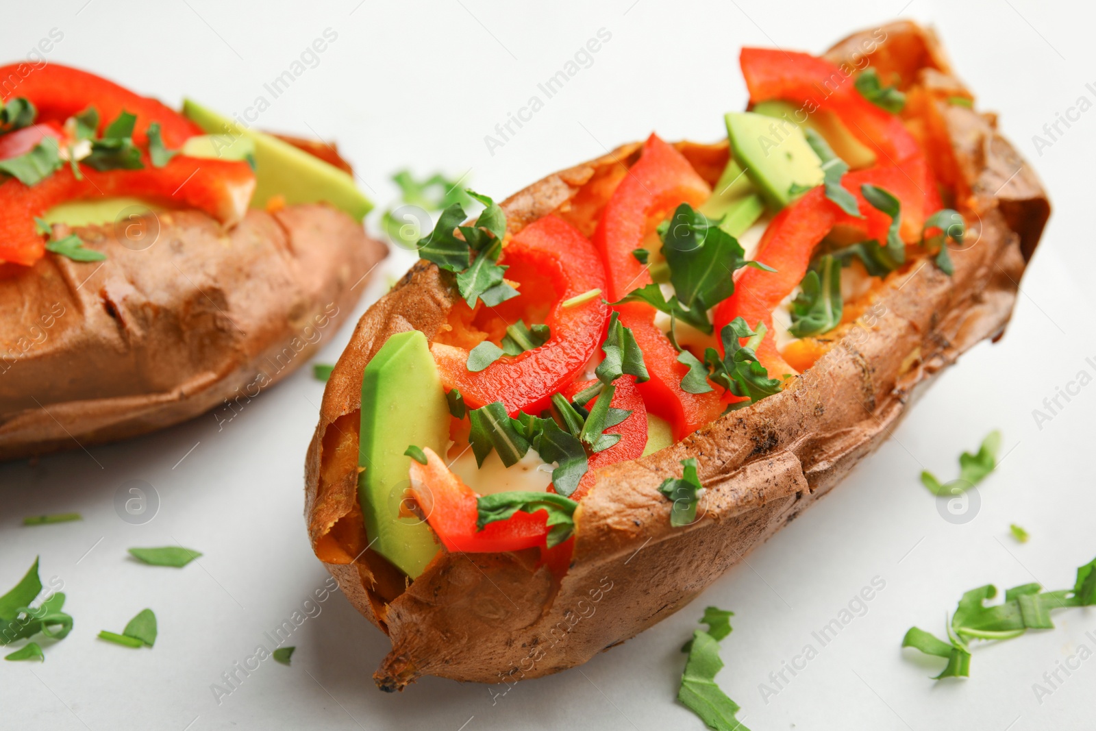 Photo of Stuffed sweet potatoes served on parchment, closeup