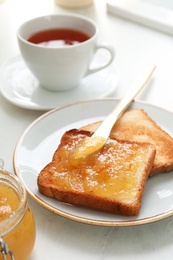 Photo of Breakfast with delicious orange marmalade on table