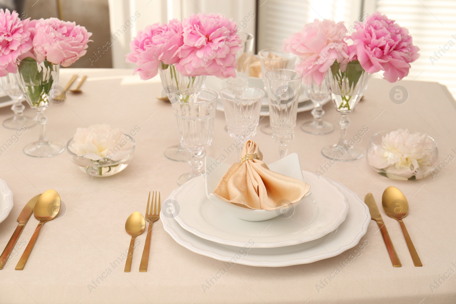 Photo of Stylish table setting with beautiful peonies and fabric napkin indoors
