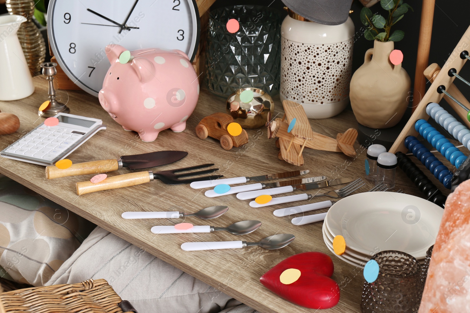 Photo of Many different items on wooden table indoors. Garage sale