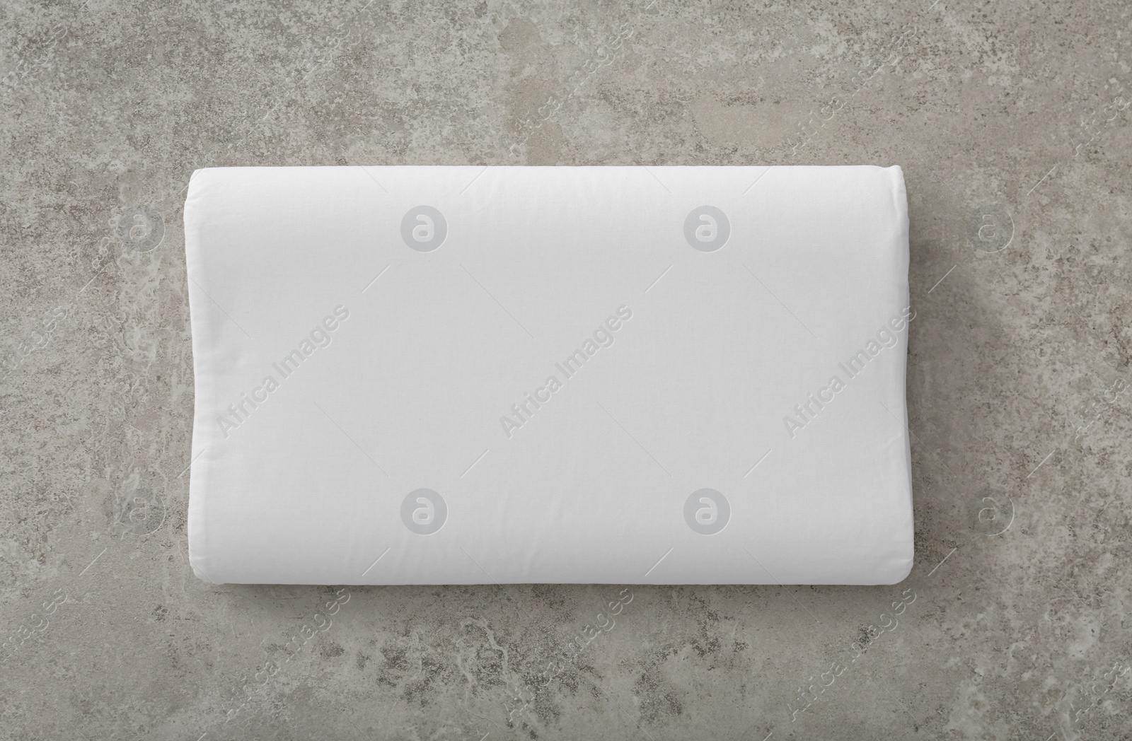 Photo of Soft bed pillow on gray background, top view