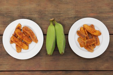 Photo of Delicious fried bananas and fresh fruits on wooden table, flat lay