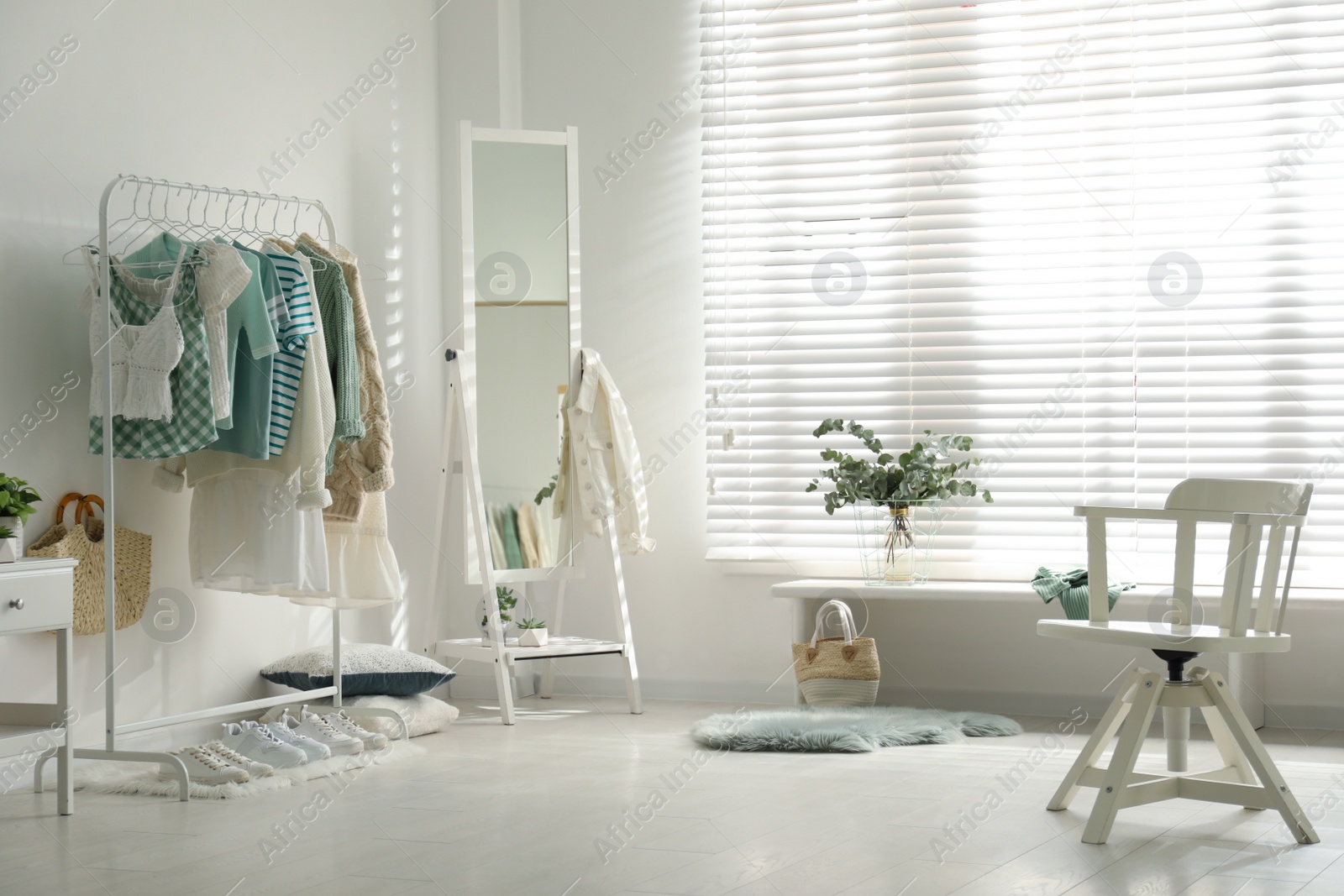 Photo of Dressing room interior with clothing rack and mirror