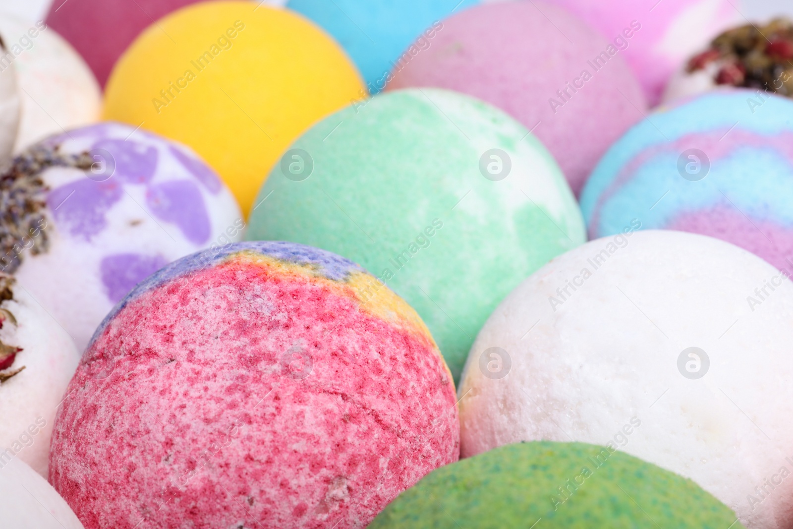 Photo of Colorful bath bombs as background, closeup view