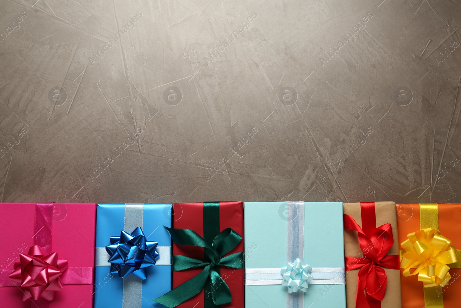 Photo of Many colorful gift boxes on grey table, flat lay. Space for text