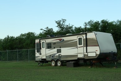 Photo of Travel trailer parked outdoors. Home on wheels