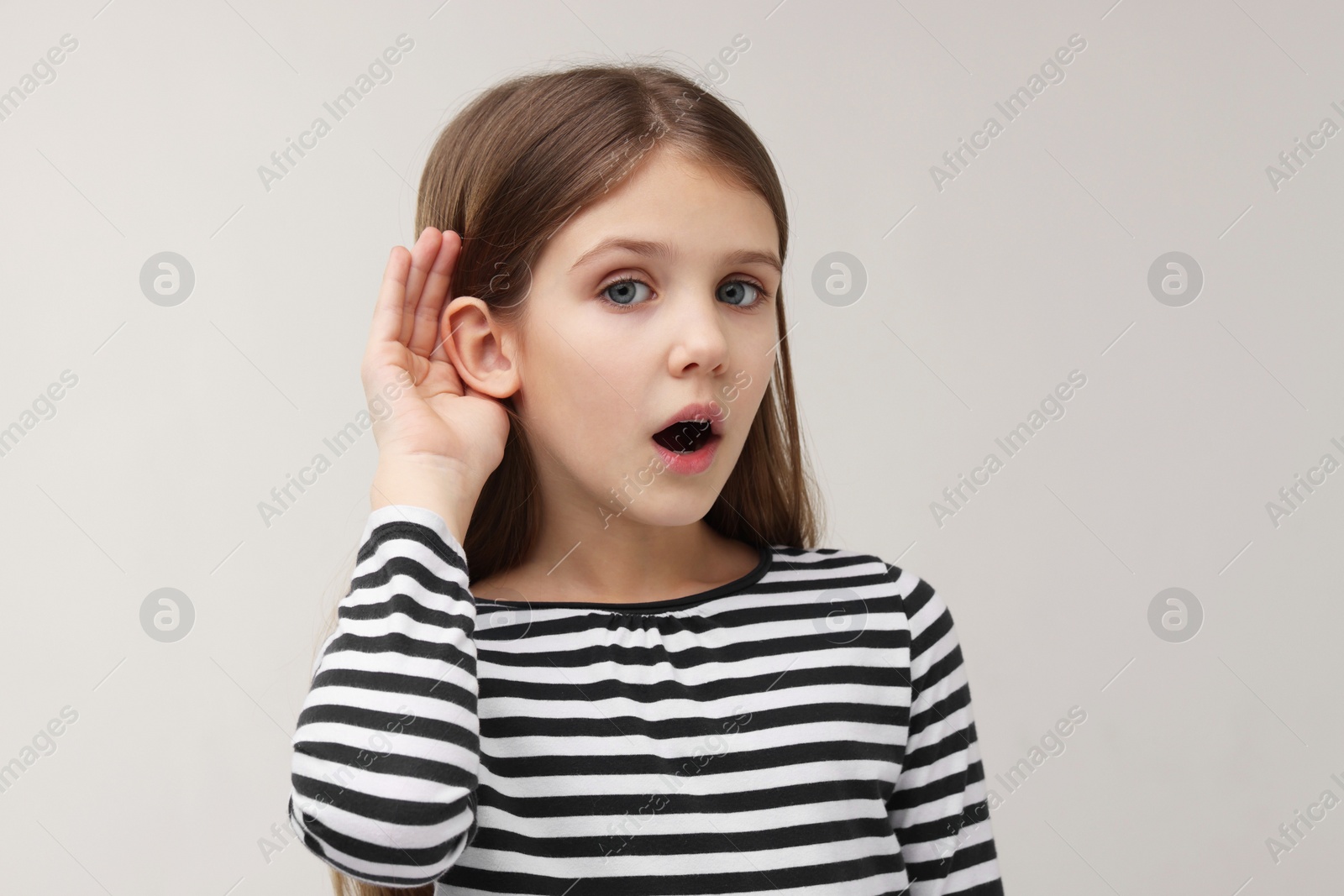 Photo of Little girl with hearing problem on grey background