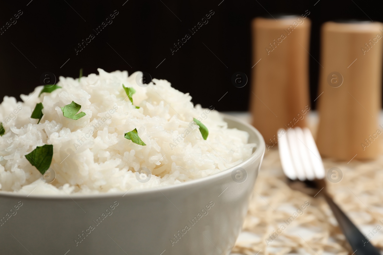 Photo of Boiled rice in bowl on table, closeup. Space for text