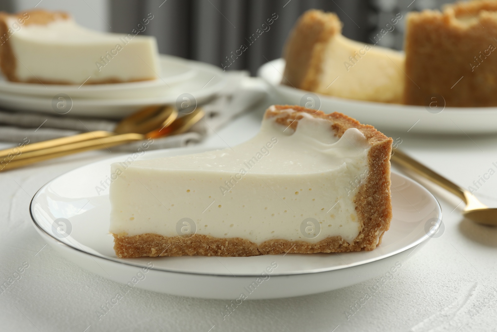 Photo of Piece of tasty vegan tofu cheesecake on white table, closeup