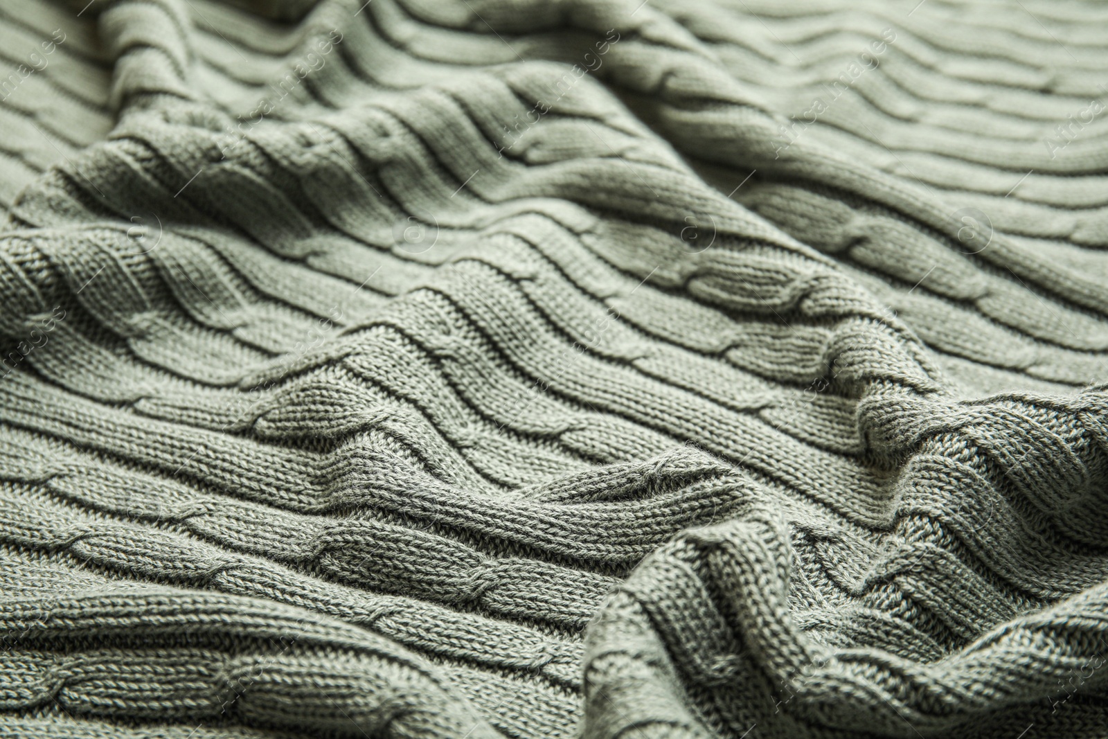 Photo of Soft knitted plaid as background, closeup view