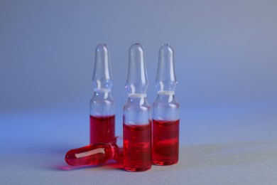 Photo of Pharmaceutical ampoules with medication on color background