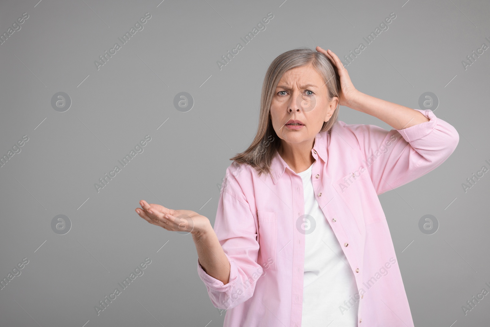 Photo of Portrait of surprised senior woman on grey background, space for text