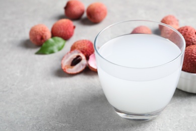 Photo of Freshly made lychee juice on light table, closeup. Space for text