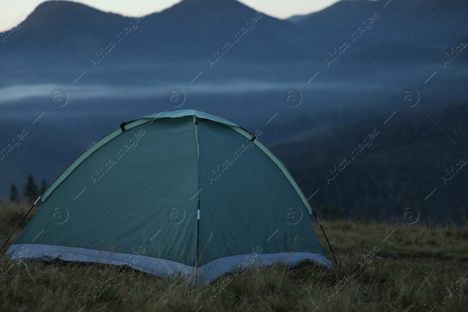 Photo of Camping tent in mountains on early morning