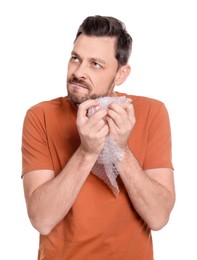 Photo of Man popping bubble wrap on white background. Stress relief