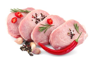 Pieces of raw pork meat, chili peppers and spices isolated on white