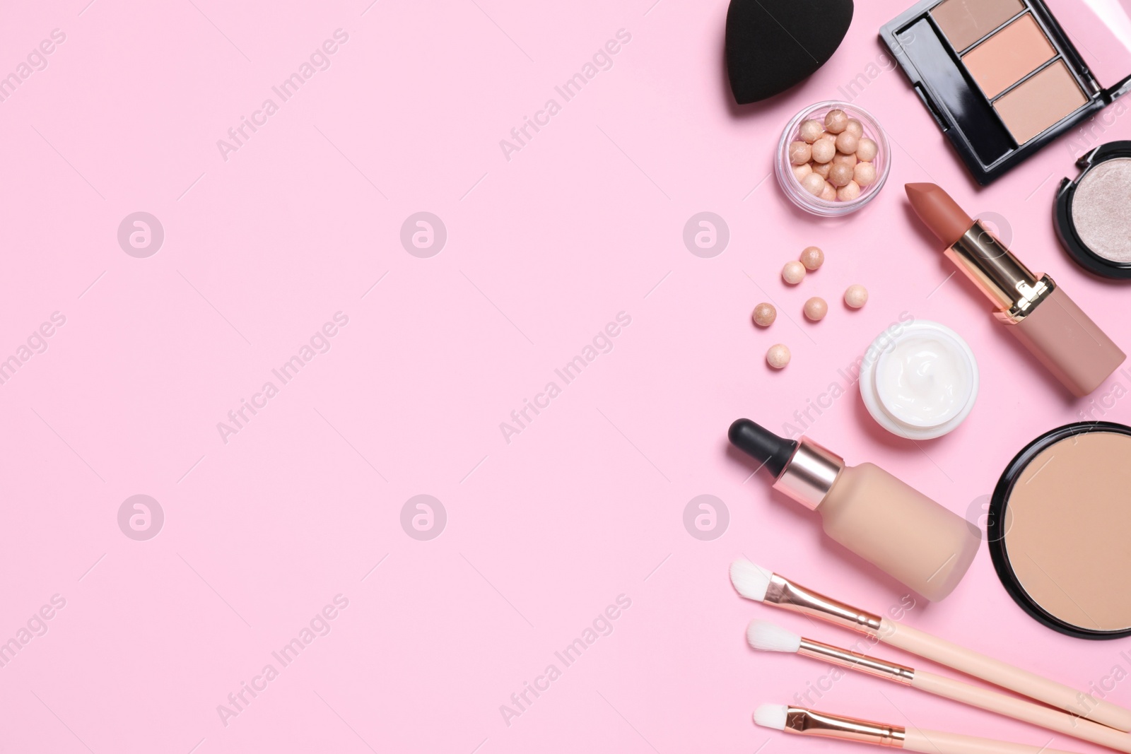 Photo of Flat lay composition with decorative cosmetics on  pink background, space for text