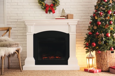 Photo of Beautiful living room interior with decorated Christmas tree and modern fireplace