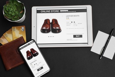 Photo of Online shopping. Flat lay composition with modern tablet and smartphone on black background