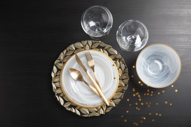 Elegant table setting on dark background, top view