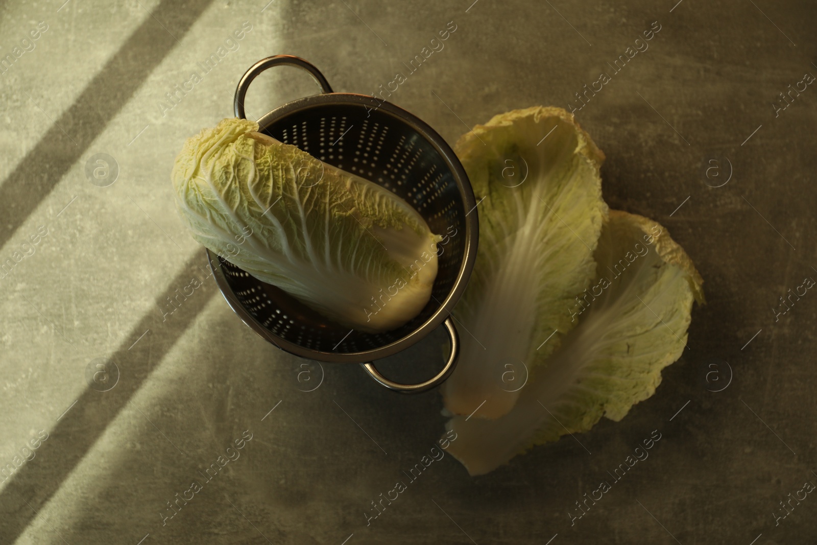 Photo of Fresh ripe Chinese cabbage and leaves on light grey table, flat lay