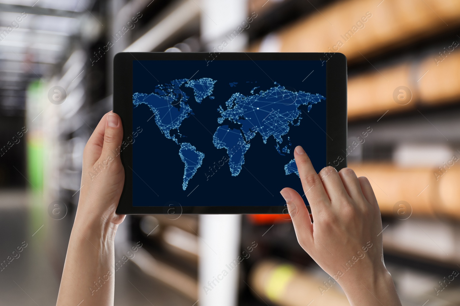 Image of Wholesale trading. Woman using tablet with world map illustration at warehouse, closeup 