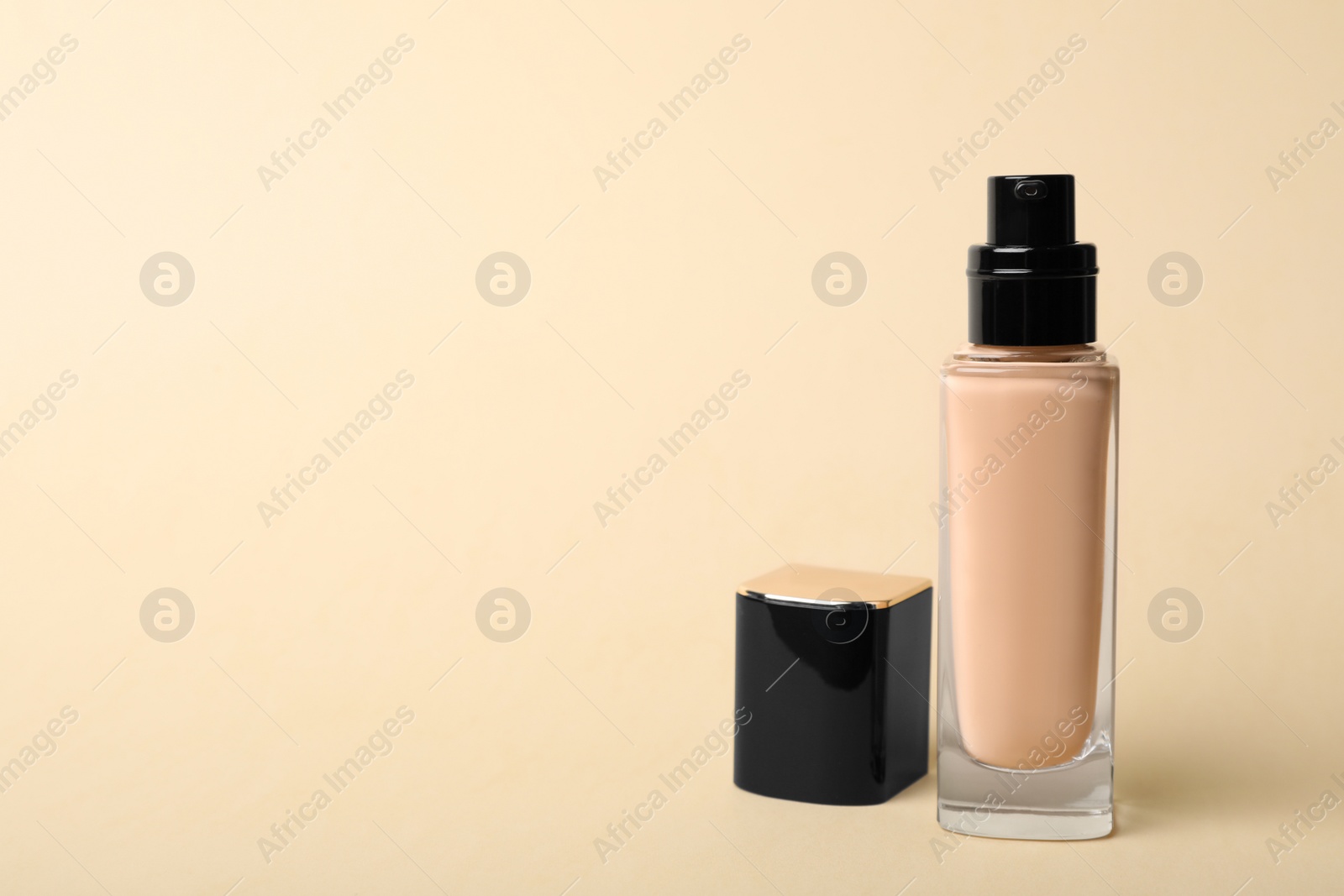 Photo of Bottle of skin foundation and space for text on color background