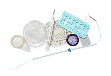 Contraceptive pills, condoms and intrauterine device isolated on white, top view. Different birth control methods