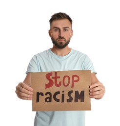 Photo of Young man holding sign with phrase Stop Racism on white background