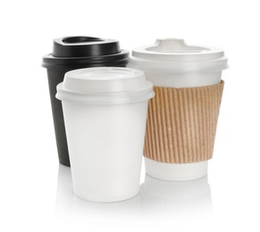 Takeaway paper coffee cups with lids on white background. Space for design