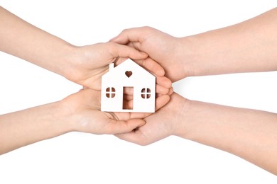 Photo of Home security concept. Couple holding house model on white background, top view