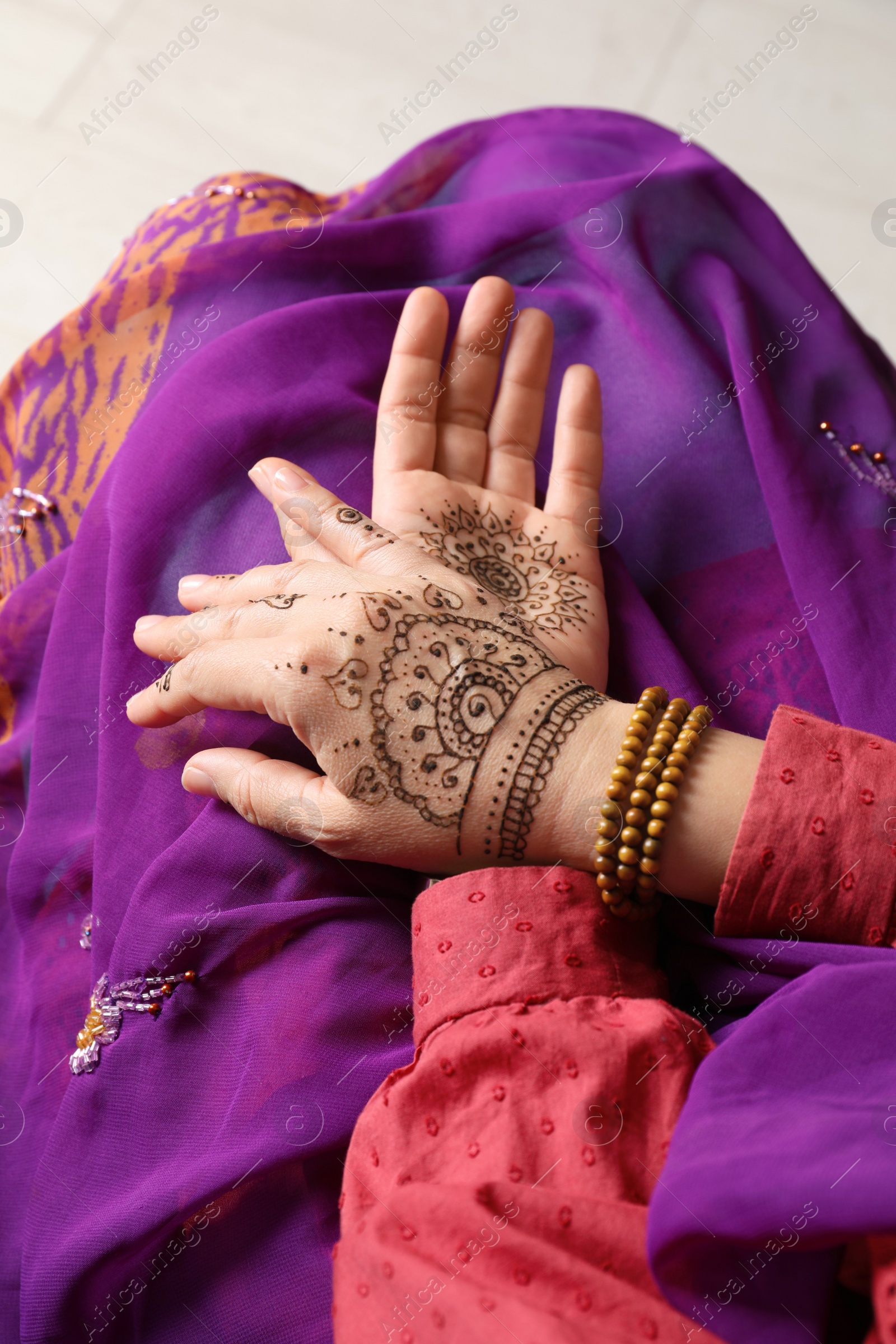 Photo of Woman with beautiful henna tattoos on hands, closeup. Traditional mehndi