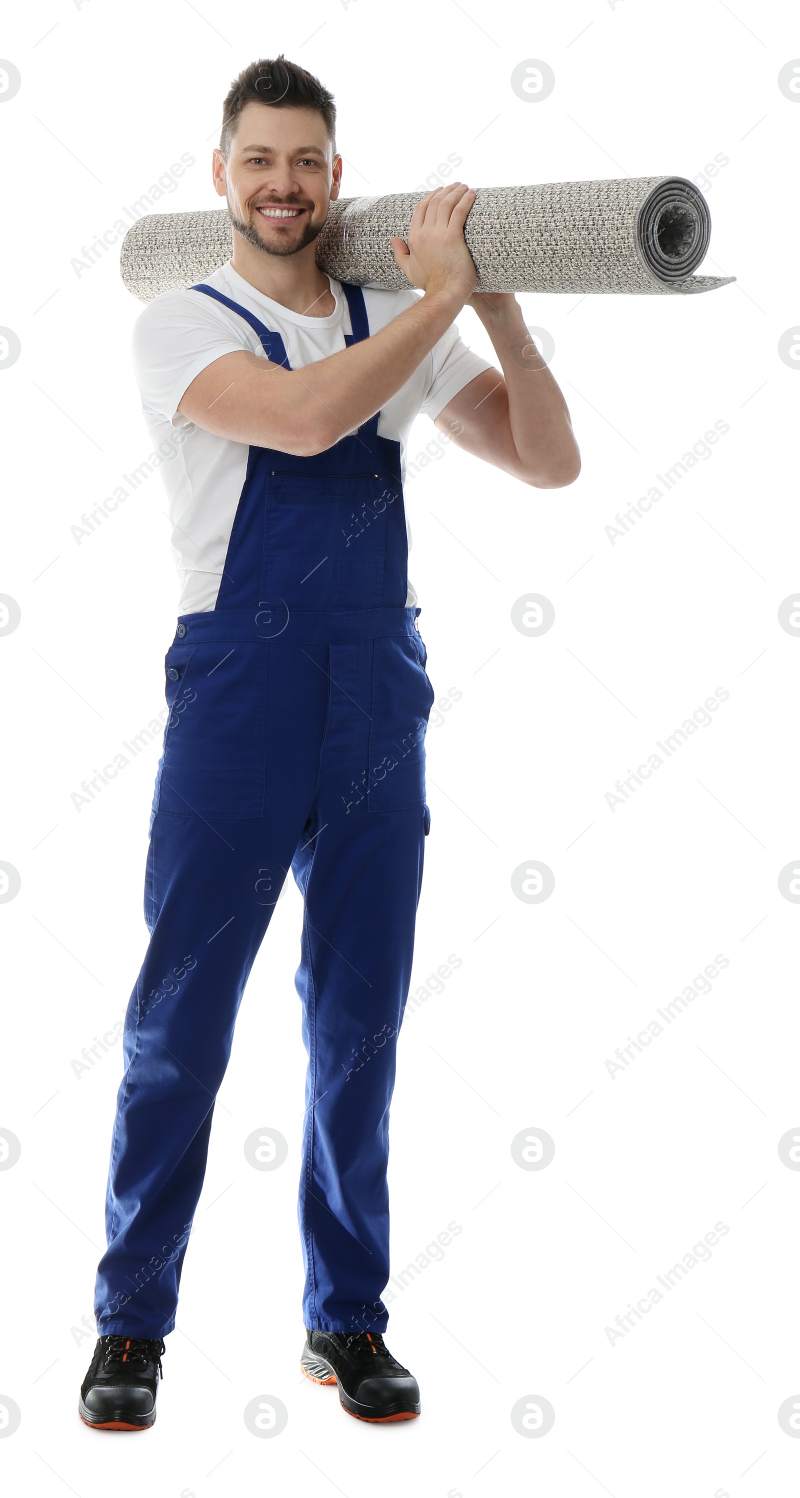 Photo of Male worker with rolled carpet on white background