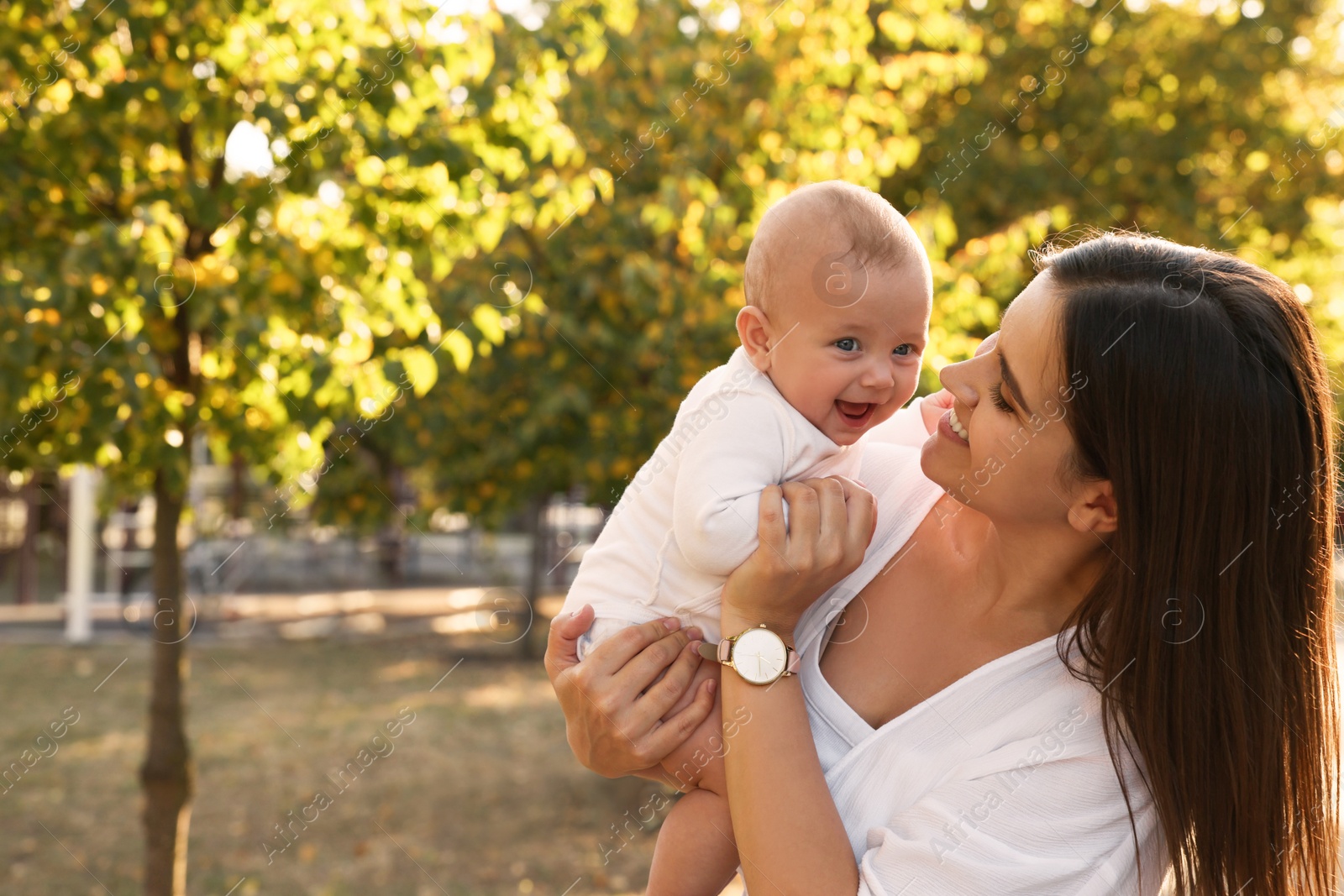 Photo of Young mother with her cute baby in park on sunny day