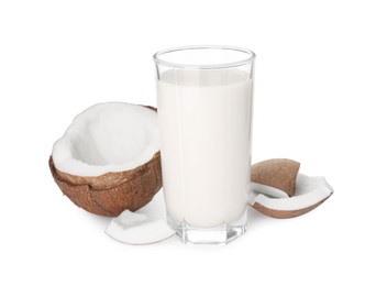 Photo of Glass of delicious vegan milk and coconut pieces on white background