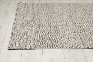 Photo of Soft grey carpet on white laminated floor indoors