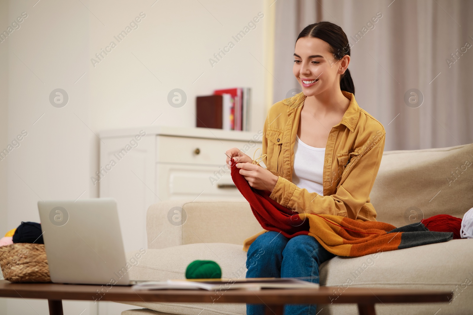 Photo of Teacher conducting online knitting course at home. Time for hobby