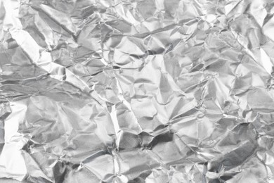 Photo of Crumpled silver foil as background, closeup view