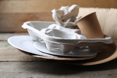 Photo of Different waste paper on wooden table, closeup