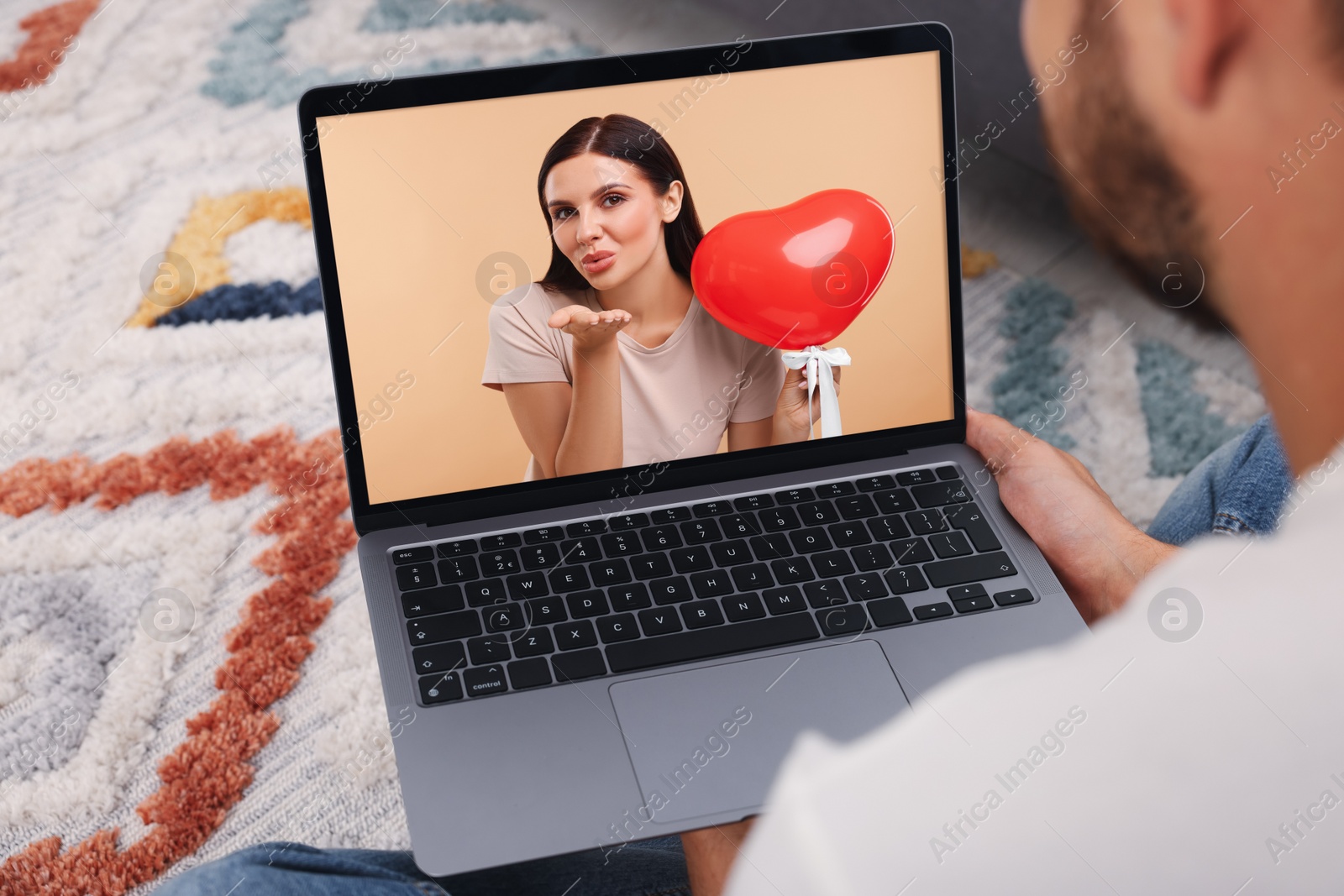 Image of Long distance love. Man having video chat with his girlfriend via laptop at home, closeup