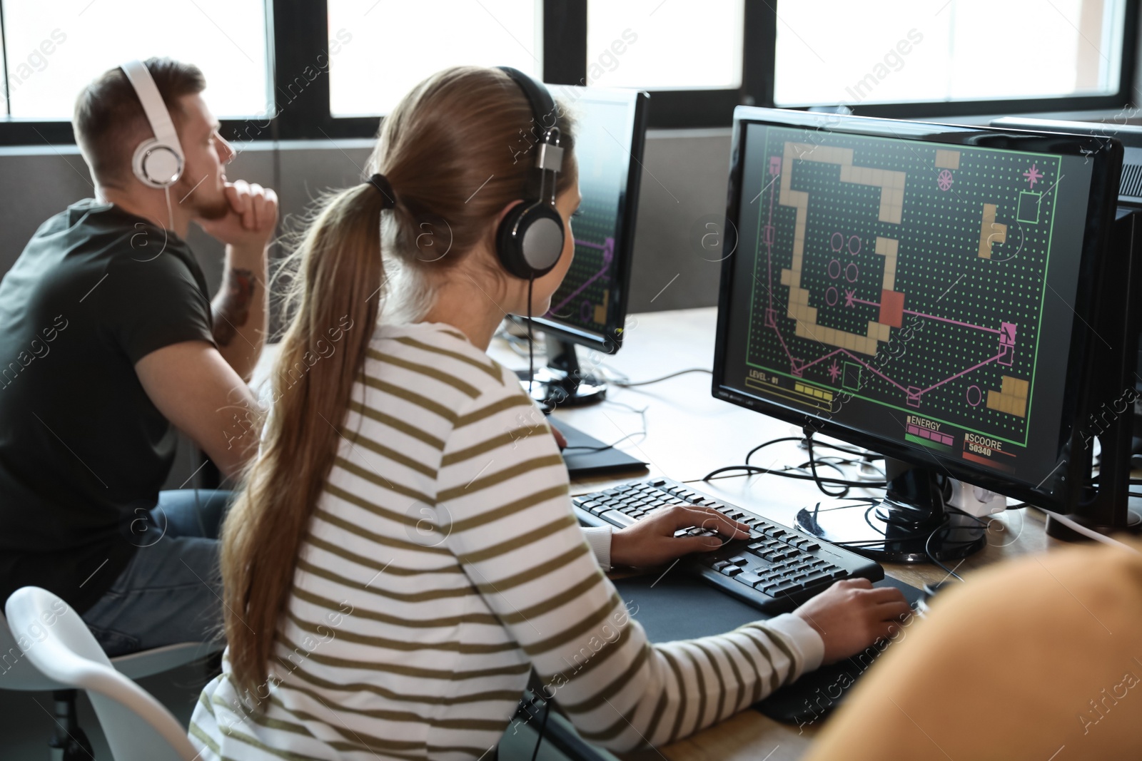 Photo of Woman playing video game in internet cafe