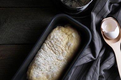 Raw dough and flour on wooden table, flat lay with space for text. Cooking ciabatta